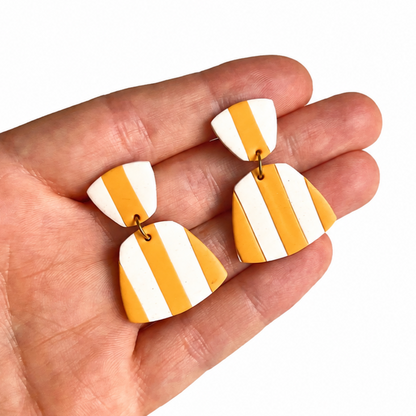 gestreepte polymeerklei oorbellen op hand, gemaakt met de Romy cuter